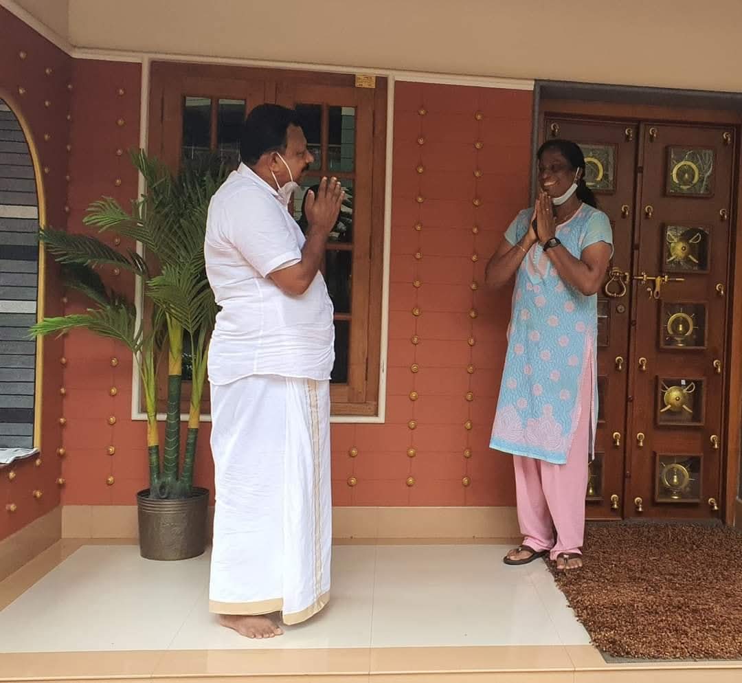 Saleem Madavoor greeting a resident at her home
